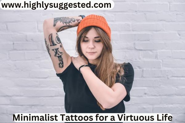 Young woman with tattooed arm standing next to white wall